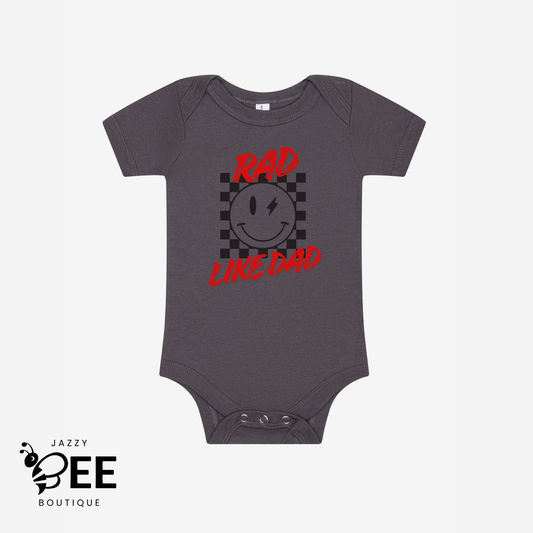 Gray baby onesie with red and black graphic and text on a white background, featuring the brand 'Jazzy Bee Boutique'.