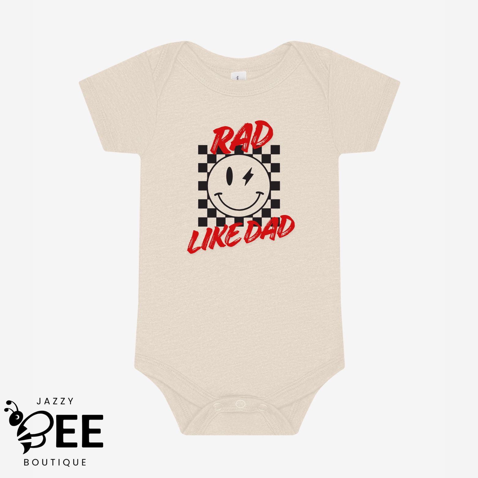 Beige baby onesie with a smiley face and text design on a white background, featuring the brand 'Jazzy Bee Boutique'.