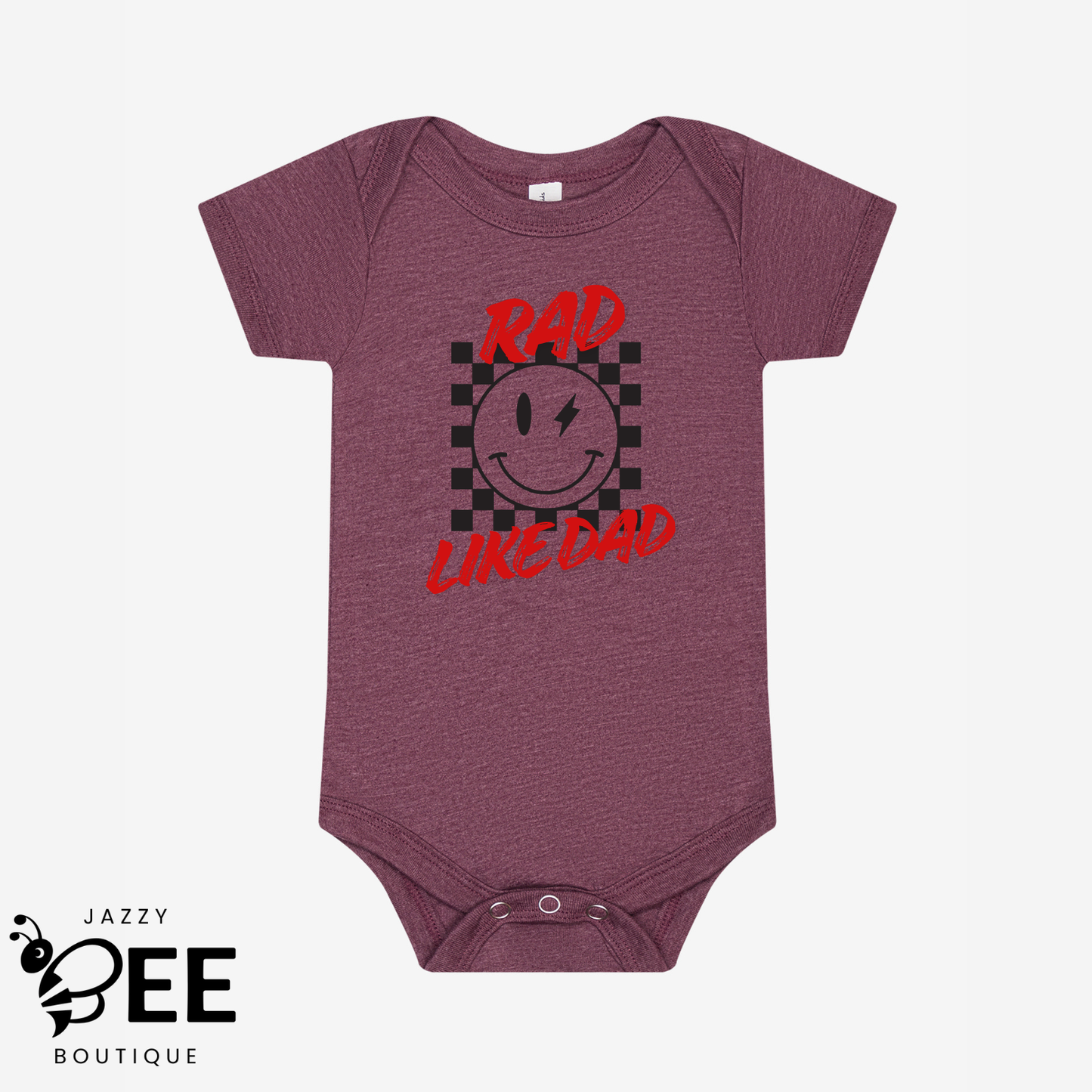 Maroon baby onesie with a smiley face and text on a white background, featuring the brand 'Jazzy Bee Boutique'.
