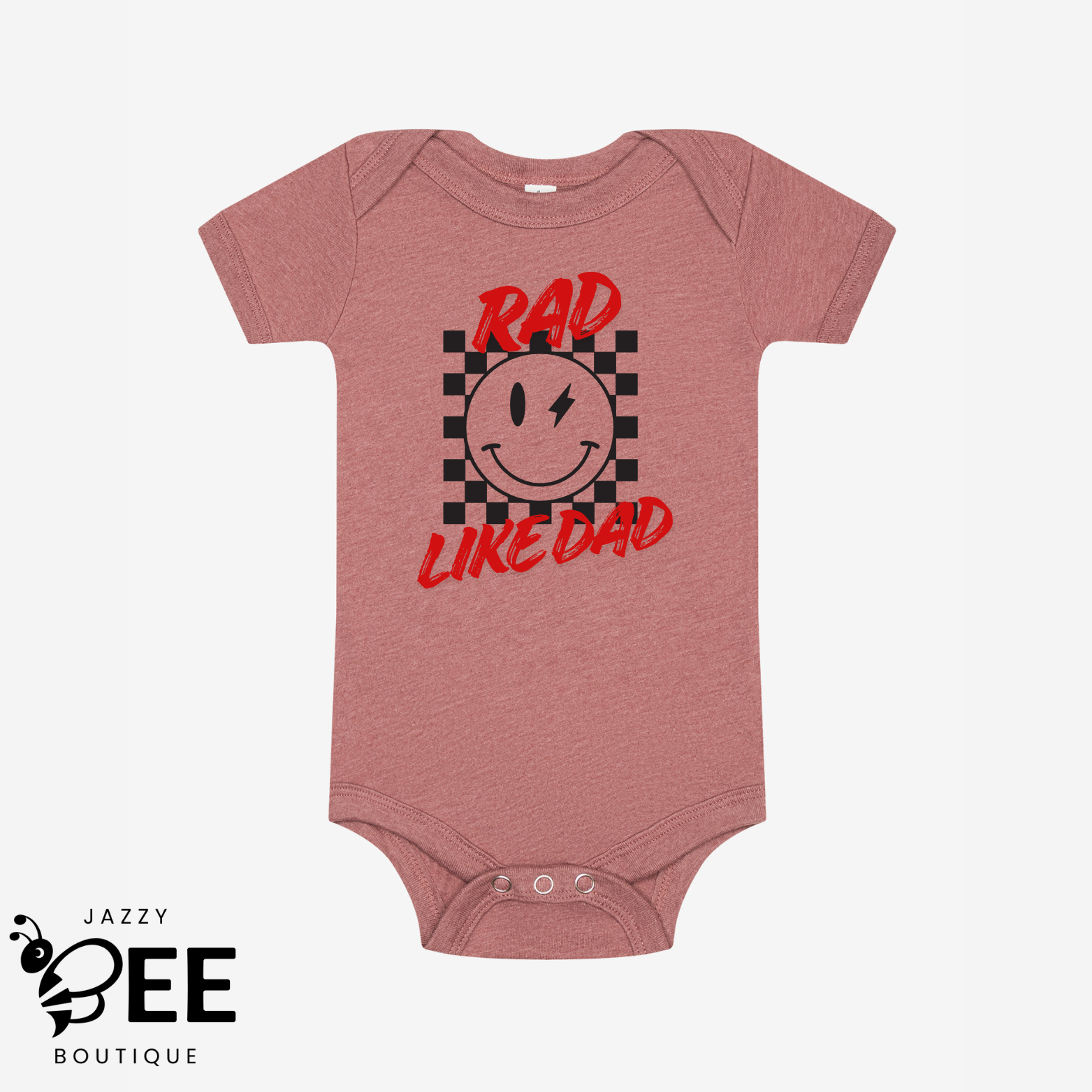 Pink baby onesie with smiley face and text 'Rad Like Dad' on a white background, featuring the Jazzy Bee Boutique logo.