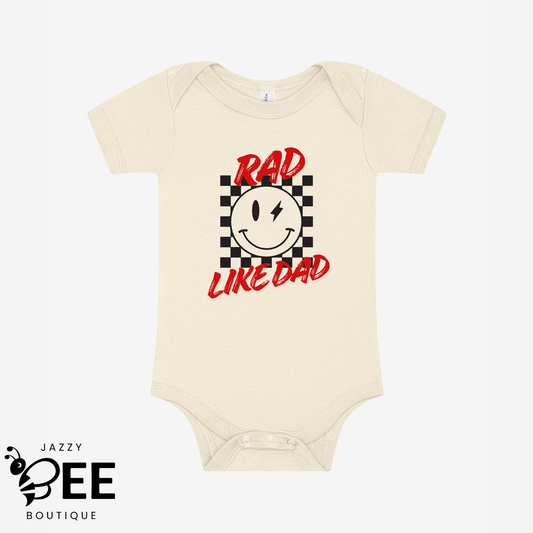 Natural baby onesie with a smiley face and text 'Rad Like Dad' on a white background, featuring the brand 'Jazzy Bee Boutique'.