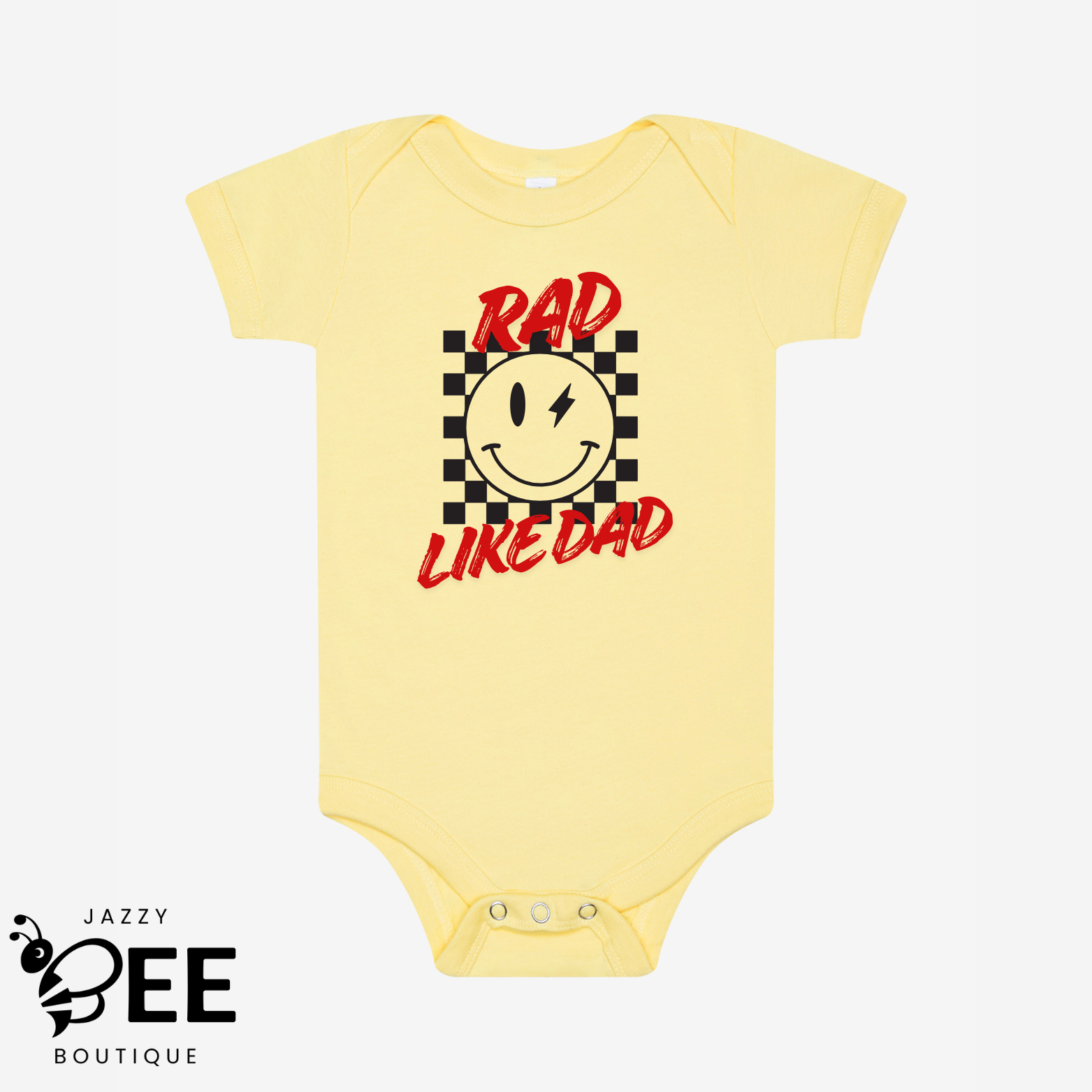 Yellow baby onesie with a smiley face and text on a white background, featuring the brand 'Jazzy Bee Boutique'.